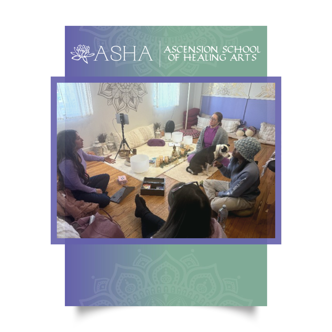 Reiki students sitting in a circle on the floor of the ASHA studio around a centre display of crystals and candles